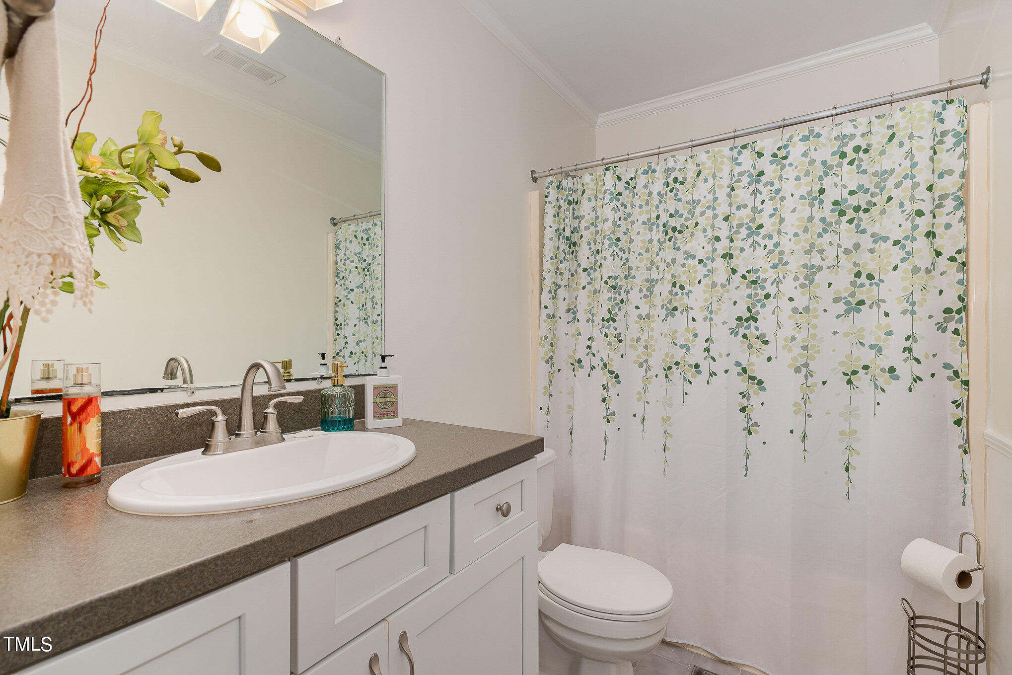 3639 Mill Run, Unit 12 Raleigh, NC 27612 - Photo 11 of 16 a bathroom with a granite countertop sink and a mirror