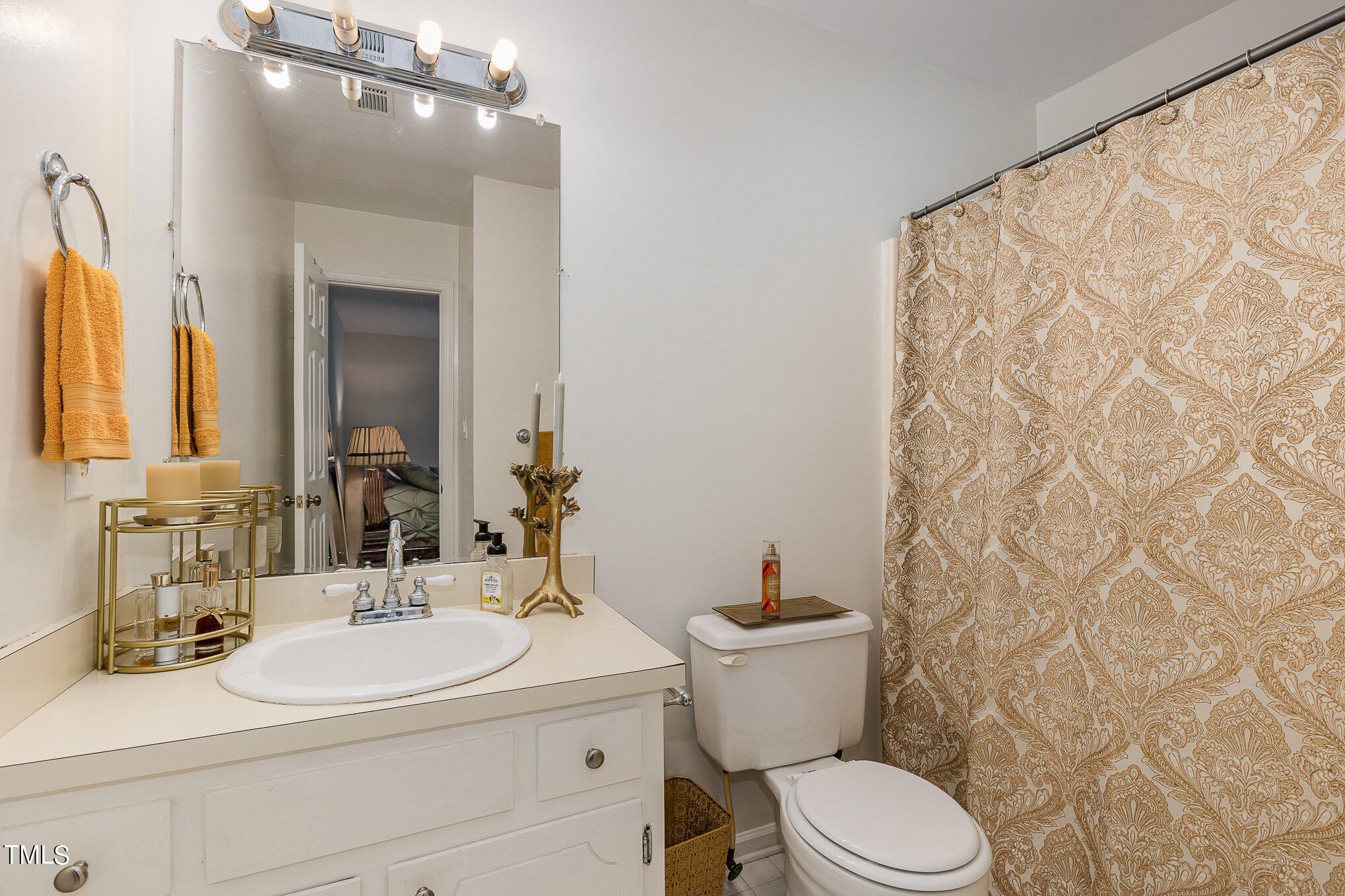 3639 Mill Run, Unit 12 Raleigh, NC 27612 - Photo 13 of 16 a bathroom with a sink a toilet and shower curtain