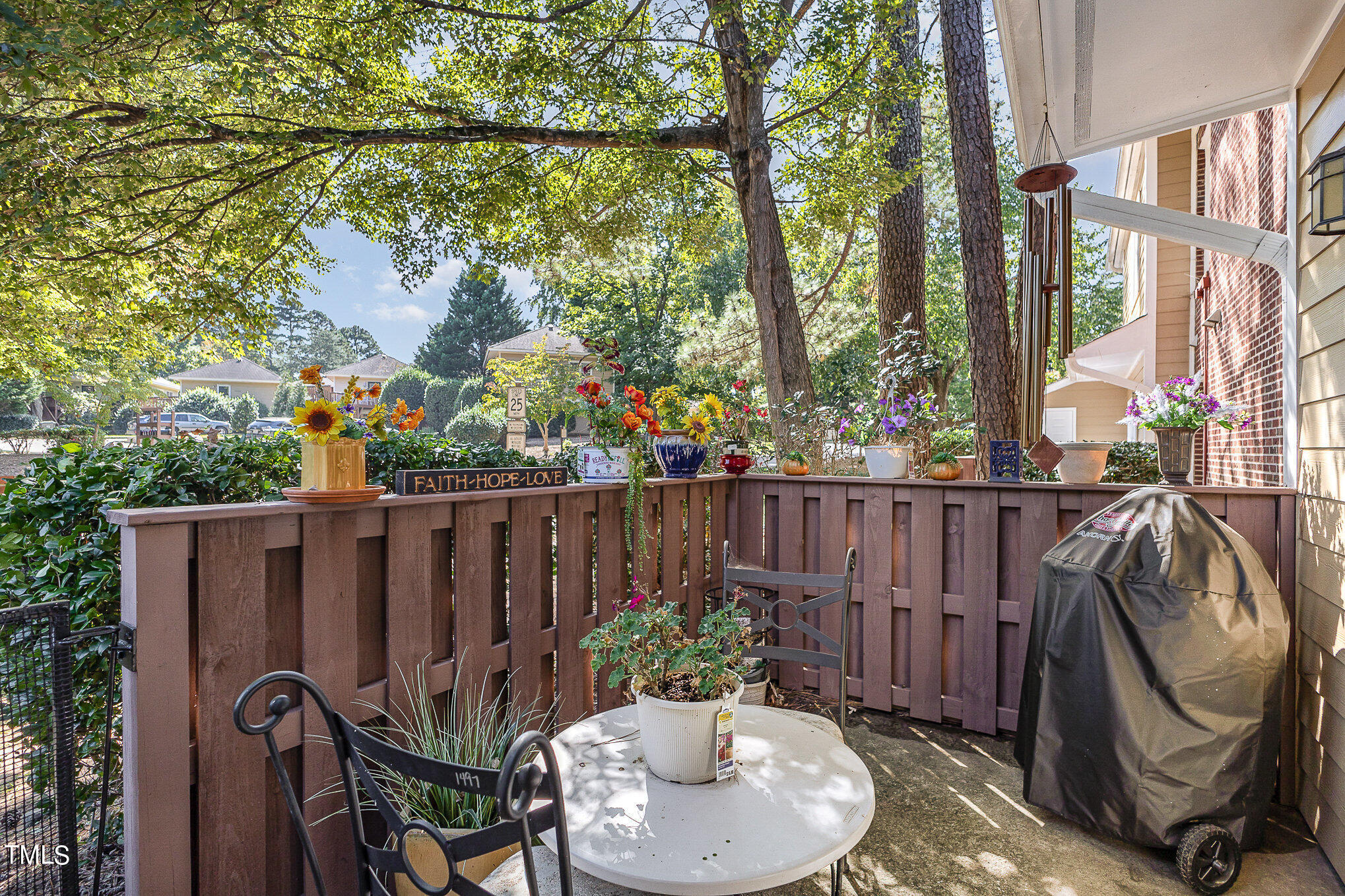 3639 Mill Run, Unit 12 Raleigh, NC 27612 - Photo 14 of 16 a view of a balcony with chair and potted plants