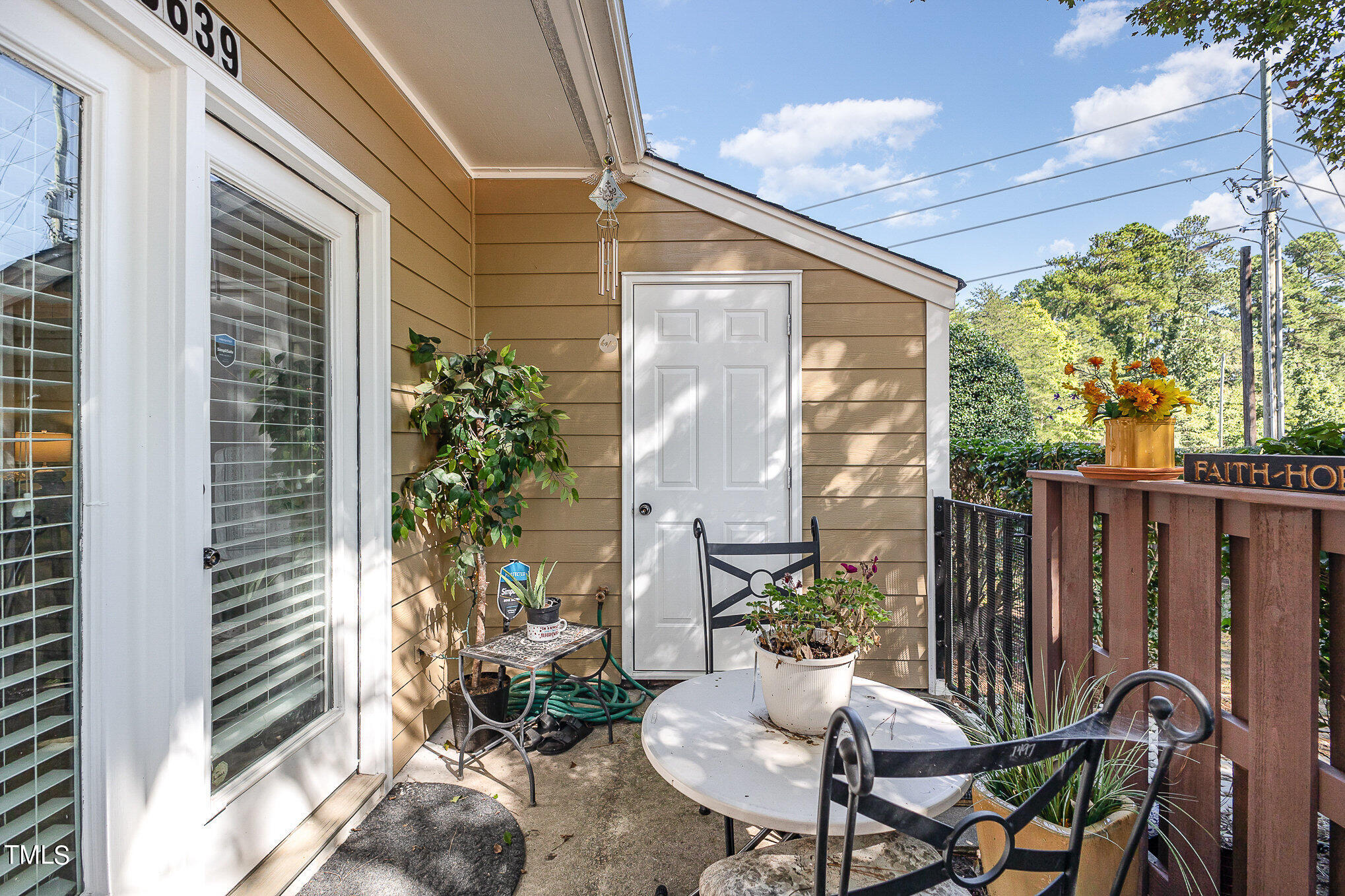 3639 Mill Run, Unit 12 Raleigh, NC 27612 - Photo 3 of 16 a view of a patio with table and chairs and potted plants