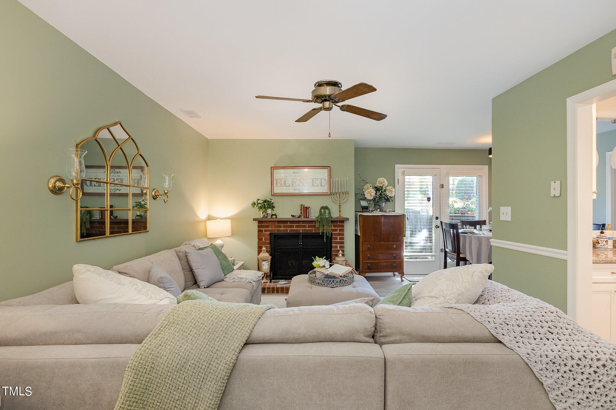 3639 Mill Run, Unit 12 Raleigh, NC 27612 - Photo 4 of 16 a living room with furniture a fireplace and a flat screen tv