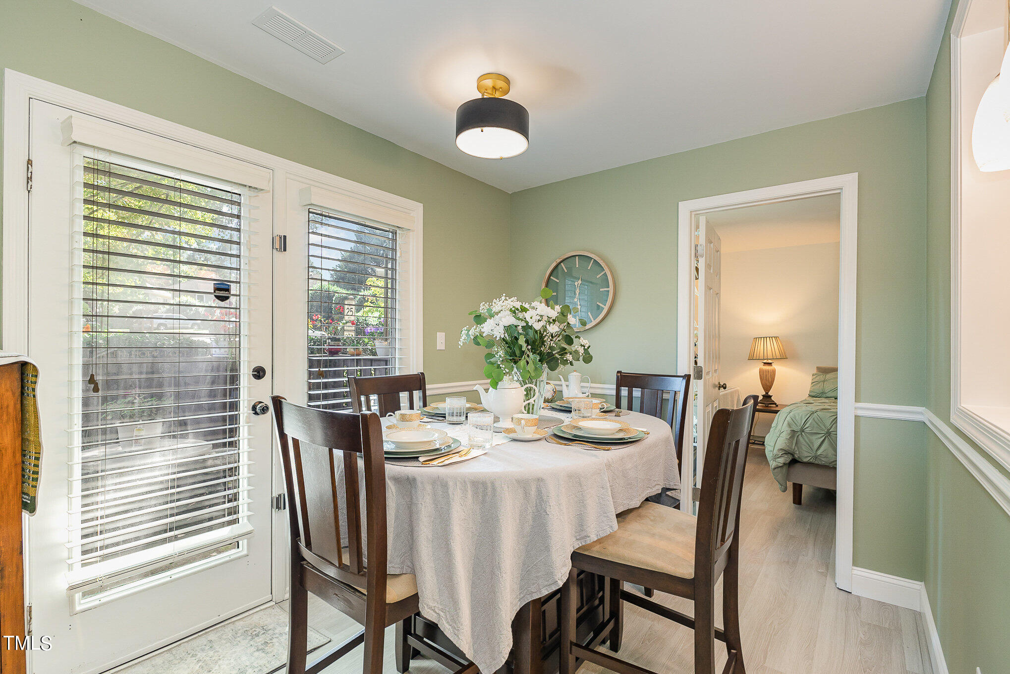 3639 Mill Run, Unit 12 Raleigh, NC 27612 - Photo 8 of 16 a view of a dining room with furniture and chandelier