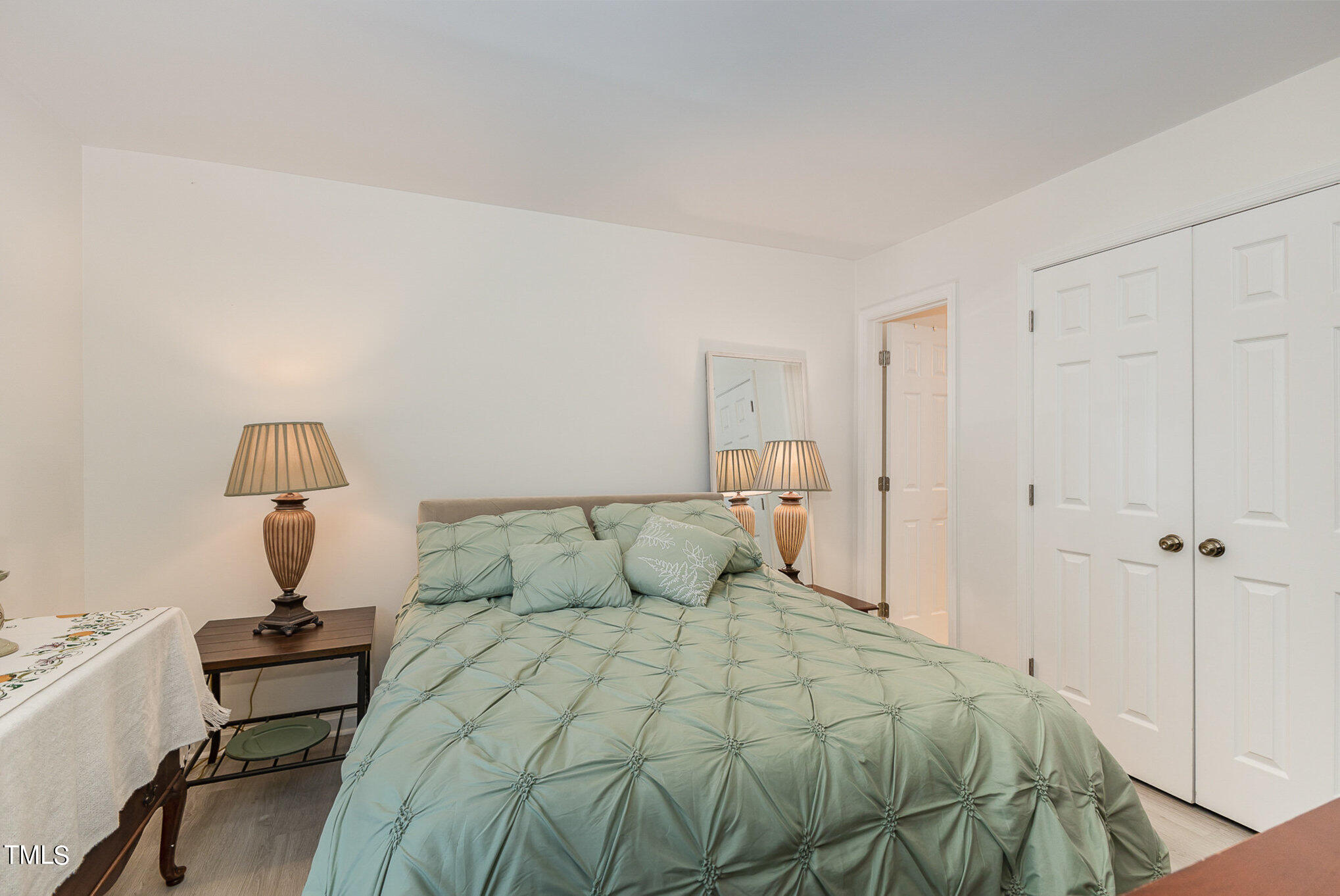 3639 Mill Run, Unit 12 Raleigh, NC 27612 - Photo 9 of 16 a bedroom with a bed and a table