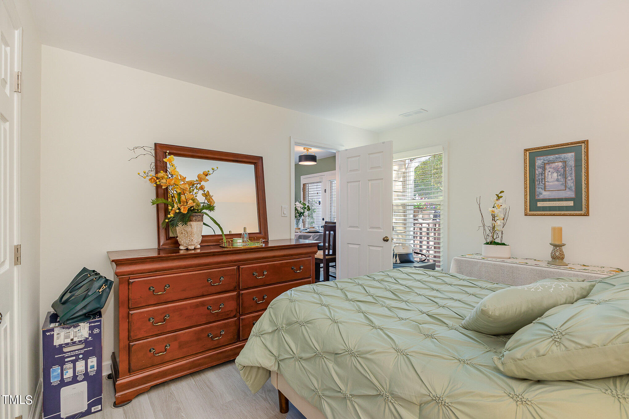 3639 Mill Run, Unit 12 Raleigh, NC 27612 - Photo 10 of 16 a bedroom with a bed and a dresser