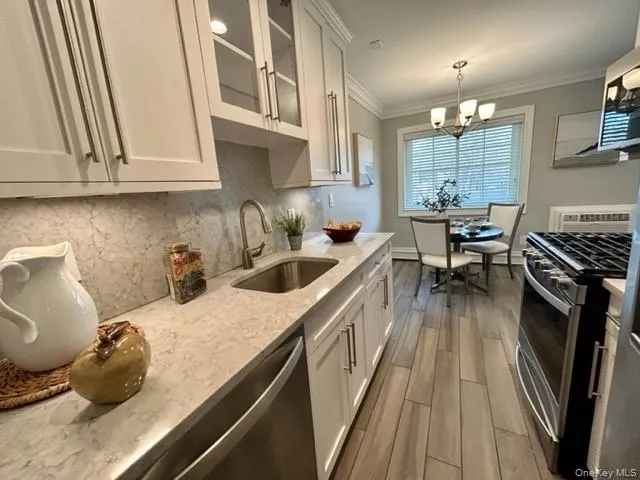 a kitchen with a sink a stove and cabinets