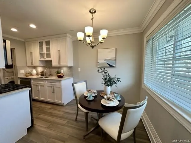 a view of a dining room with furniture and chandelier
