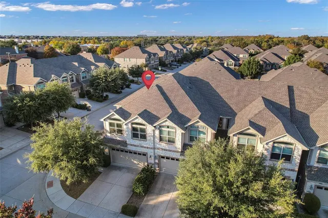 an aerial view of residential houses with outdoor space