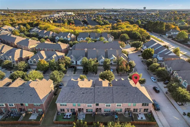 an aerial view of residential houses with outdoor space and swimming pool