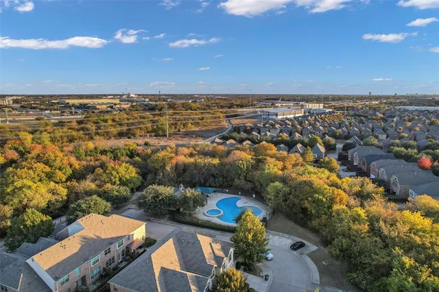 an aerial view of a houses with a yard