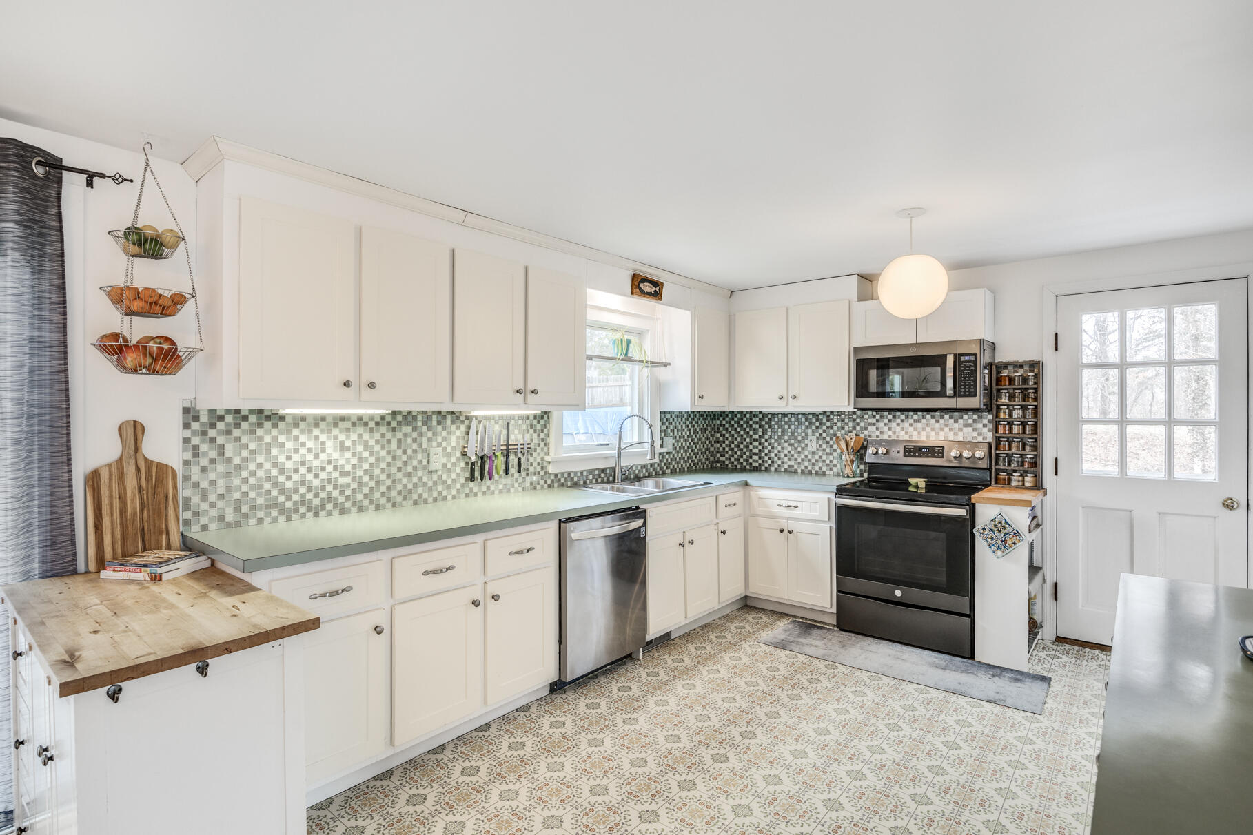 25 Cranberry Road Eastham, MA 02642 - Photo 16 of 45 a kitchen with granite countertop a sink stove and cabinets