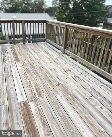 an empty room with windows and ceiling fan view