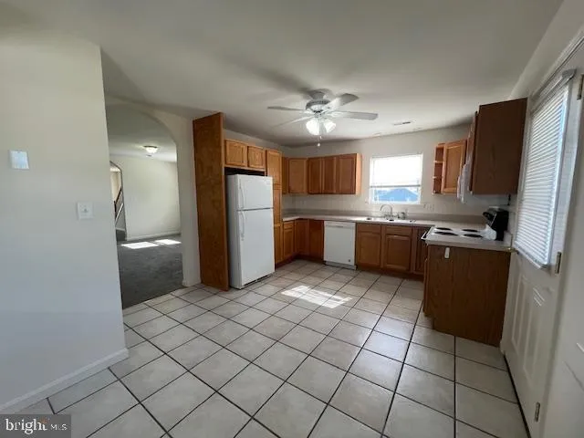 a kitchen with stainless steel appliances a stove and white cabinets