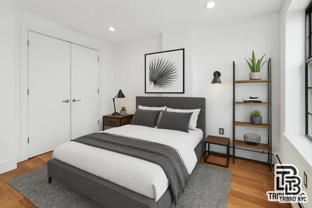 a bedroom with bed and a painting on the wall