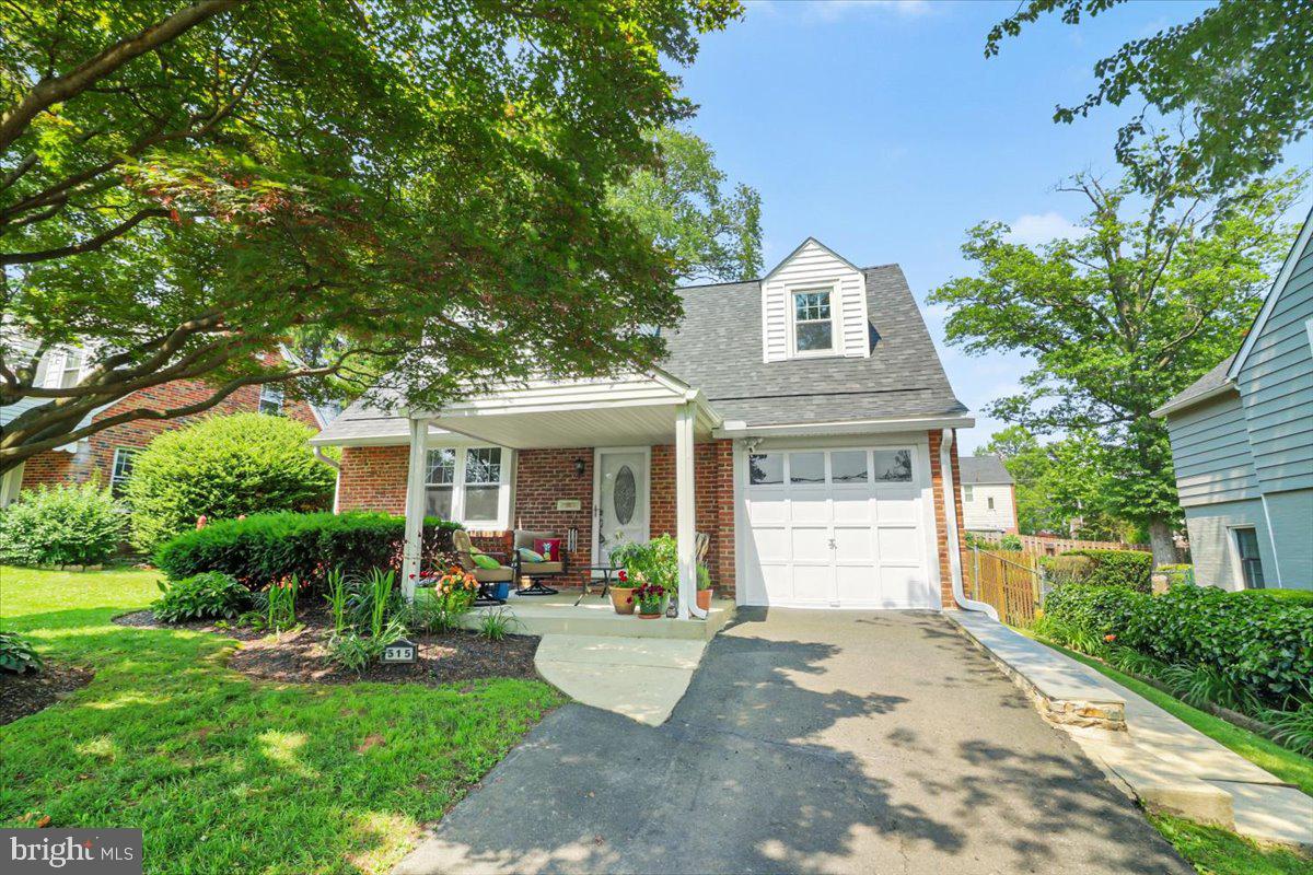 515 Arbor Road Cheltenham, PA 19012 - Photo 1 of 32 a front view of a house with a yard and potted plants