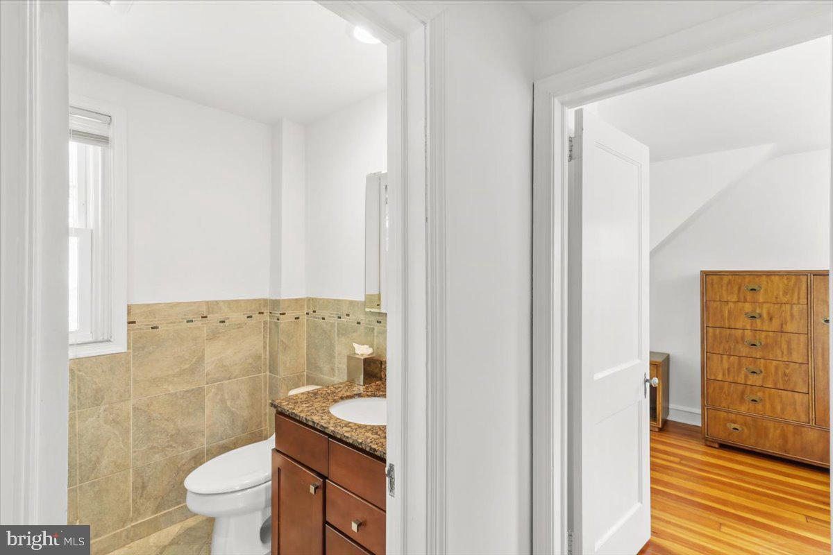 515 Arbor Road Cheltenham, PA 19012 - Photo 21 of 32 a bathroom with a granite countertop sink a toilet and shower