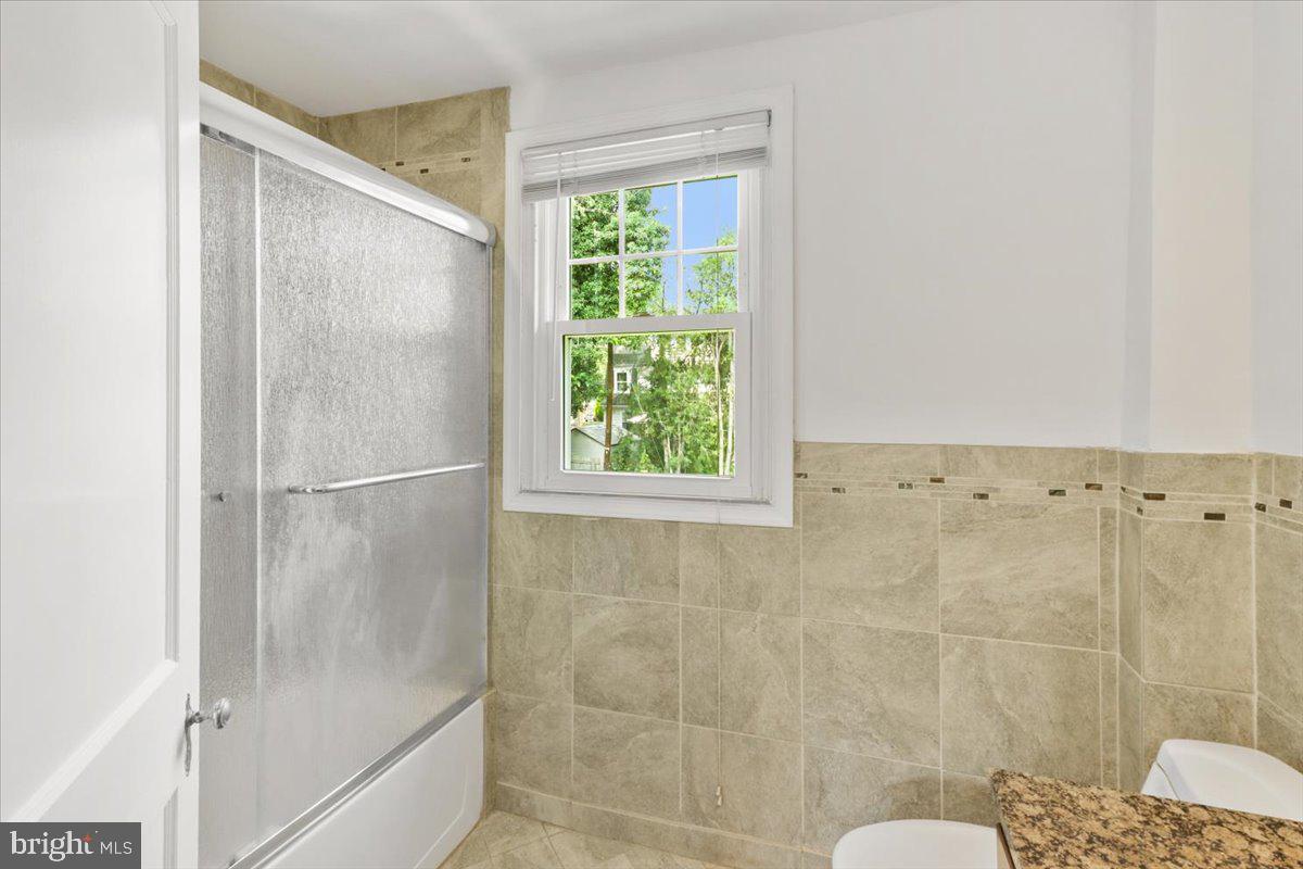 515 Arbor Road Cheltenham, PA 19012 - Photo 22 of 32 a bathroom with a glass shower door