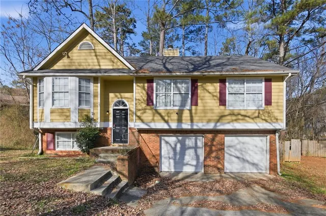 a view of a house with wooden fence