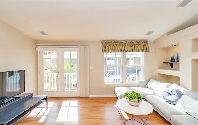 a living room with furniture and a floor to ceiling window