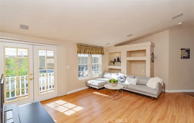 a living room with furniture and floor to ceiling windows