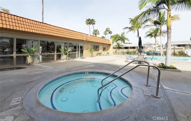 a view of a house with swimming pool and sitting area