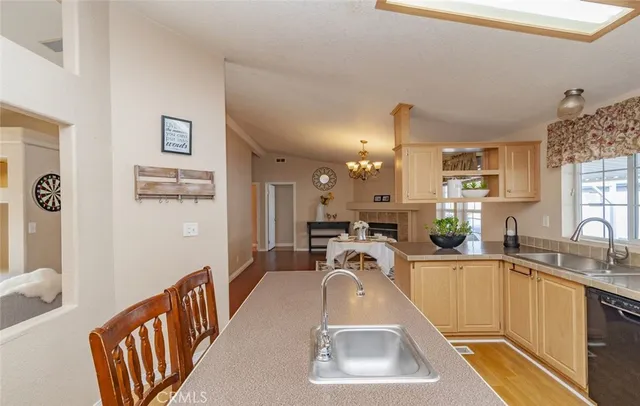 a kitchen with sink refrigerator and cabinets