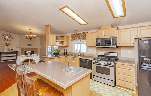 a kitchen with stainless steel appliances a stove sink microwave and cabinets