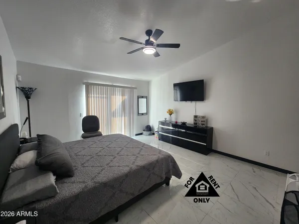 a bedroom with a bed furniture and a flat screen tv