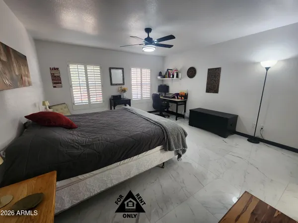 a bathroom with a toilet and a wooden floor