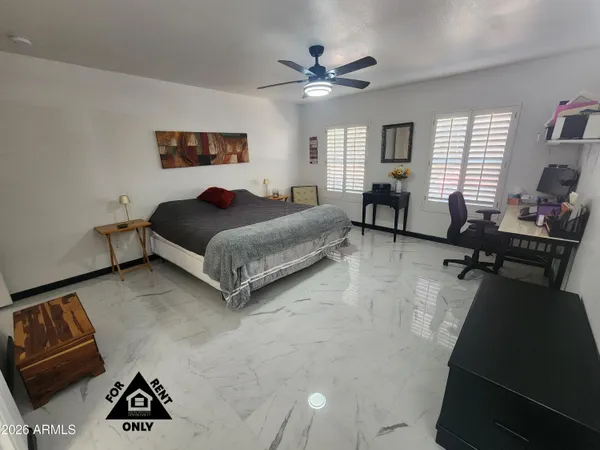 a bedroom with a bed and dresser with mirror
