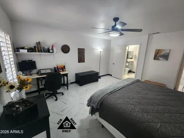 a bedroom with a bed and window