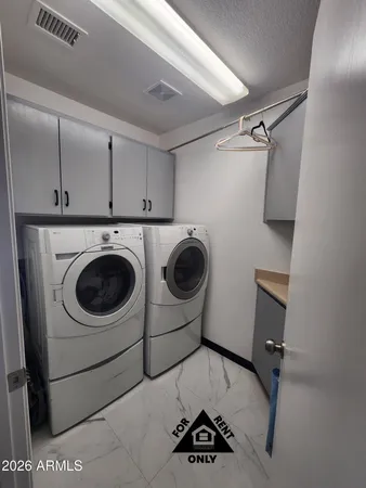 a utility room with dryer and washer
