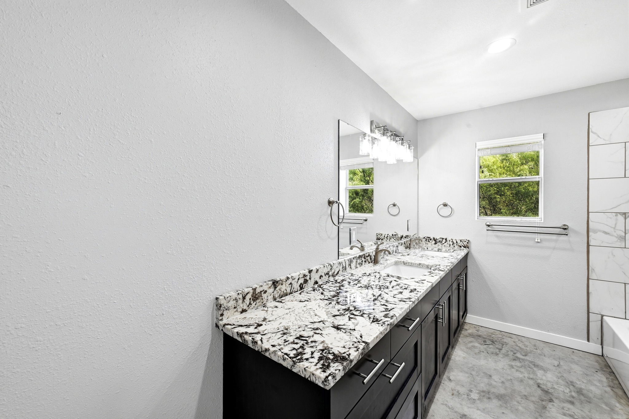 4001 Barth Road Lockhart, TX 78644 - Photo 24 of 38 Polished stone counters and rich cabinetry define this modern bath space.