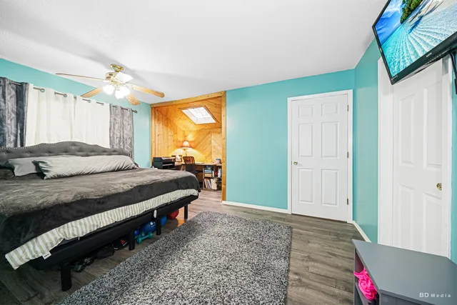 a bedroom with a bed dresser and a window