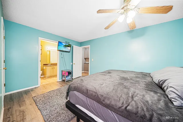 a bedroom with a bed dresser and a window