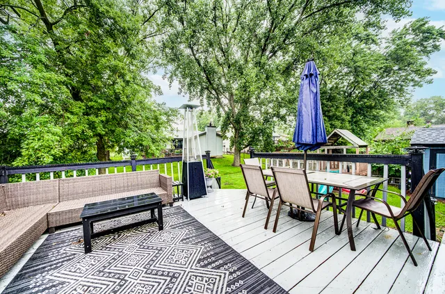 a view of a chairs and table on the wooden deck