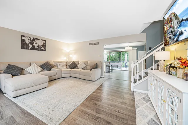 a living room with furniture and a painting on the wall