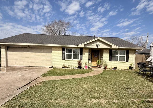 a front view of a house with a garden and porch