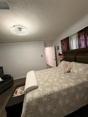 a bedroom with a bed and a lamp with window
