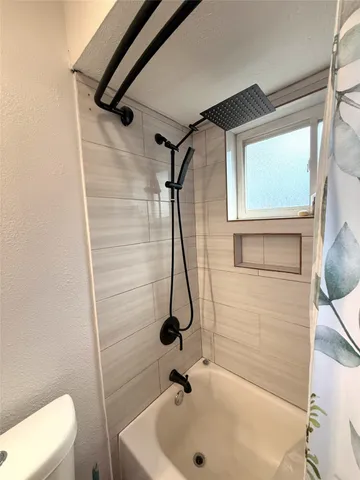 a bathroom with a sink a toilet and a shower