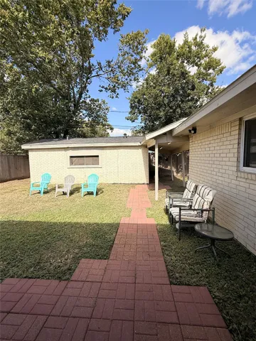 a view of a patio with two chairs and a table