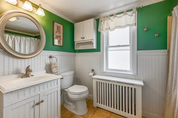 a bathroom with a sink a toilet and a mirror