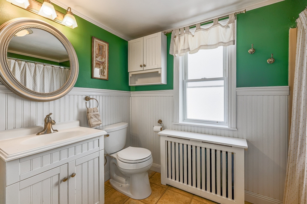 10 Metropolitan Avenue Ashland, MA 01721 - Photo 11 of 34 a bathroom with a sink a toilet and a mirror