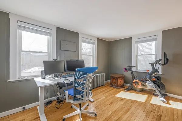 a living room with furniture a window and wooden floor