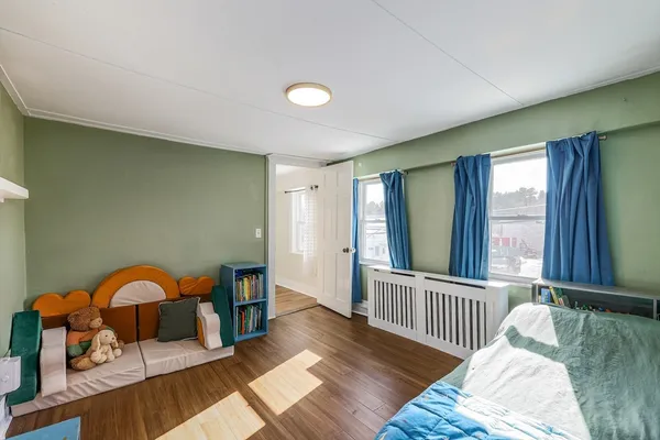 a view of a bedroom with furniture and windows
