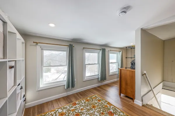 a view of an empty room with glass door and windows