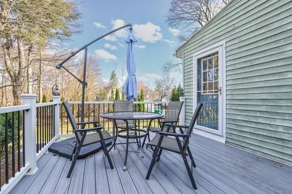 a view of a patio with table and chairs and wooden floor