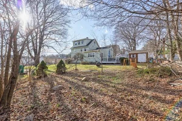 a view of a house with a yard covered in snow