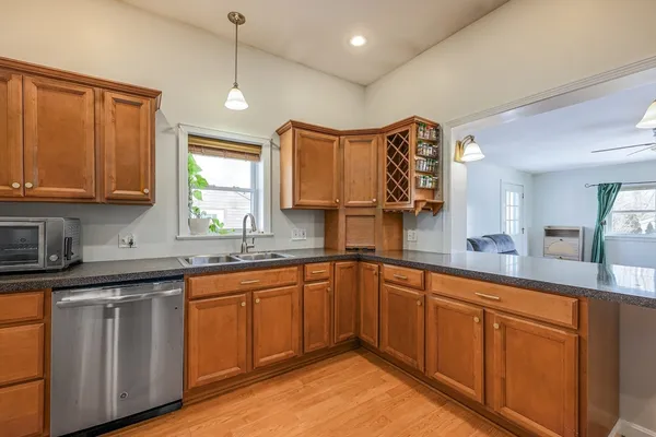 a kitchen with stainless steel appliances granite countertop wooden cabinets a sink and dishwasher