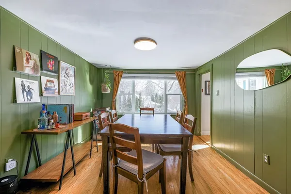 a view of a dining room with furniture and a large window
