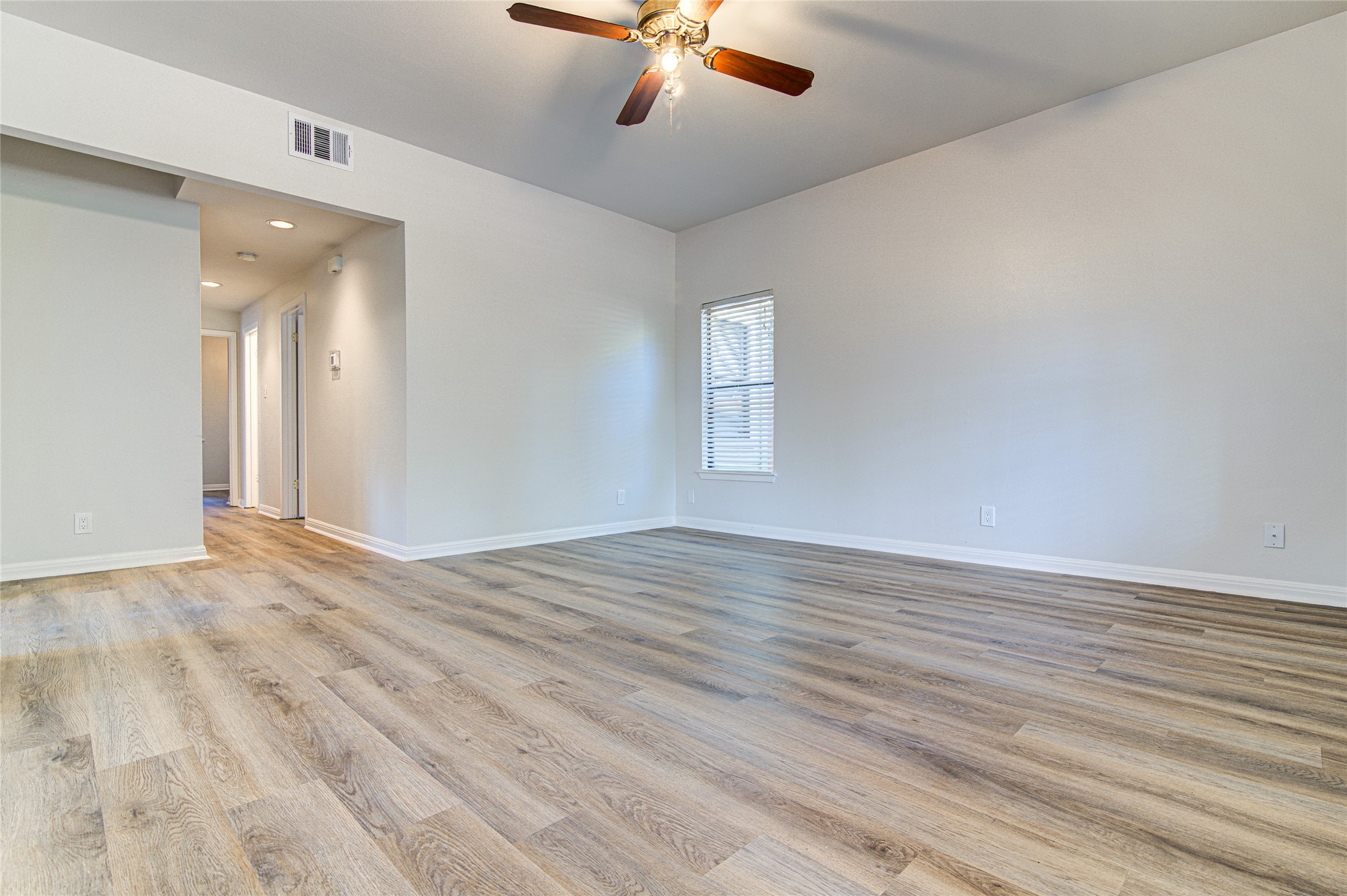 311 West Mary Street Austin, TX 78704 - Photo 25 of 35 A comfortable living space featuring recessed lighting, a ceiling fan, and attractive wood flooring.